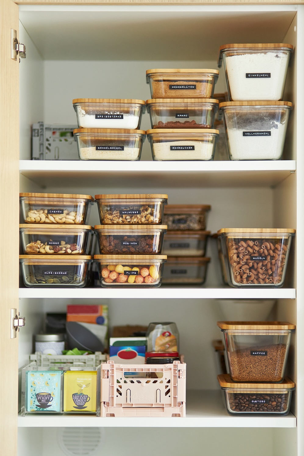 A middle-aged woman tidies up her cupboard in the kitchen and reorganizes everything to make a comparison before and after